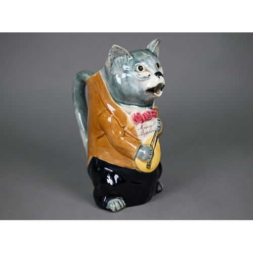 600 - A French majolica pottery novelty water-jug, modelled as a cat night-club singer with guitar, inscri... 