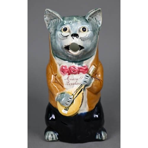 600 - A French majolica pottery novelty water-jug, modelled as a cat night-club singer with guitar, inscri... 