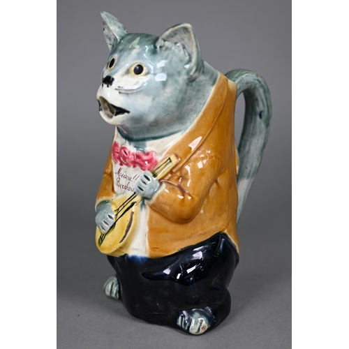 600 - A French majolica pottery novelty water-jug, modelled as a cat night-club singer with guitar, inscri... 