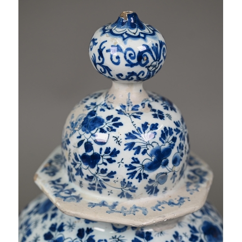 605 - An 18th century Delft blue and white vase and cover of octagonal baluster form, painted with wolves ... 