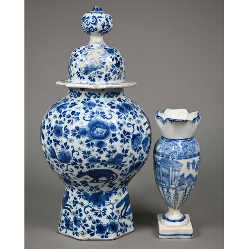 605 - An 18th century Delft blue and white vase and cover of octagonal baluster form, painted with wolves ... 