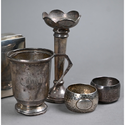 62 - A silver cigarette box, Sheffield 1919, to/w a Christening mug, two napkin rings, a weighted vase-fl... 