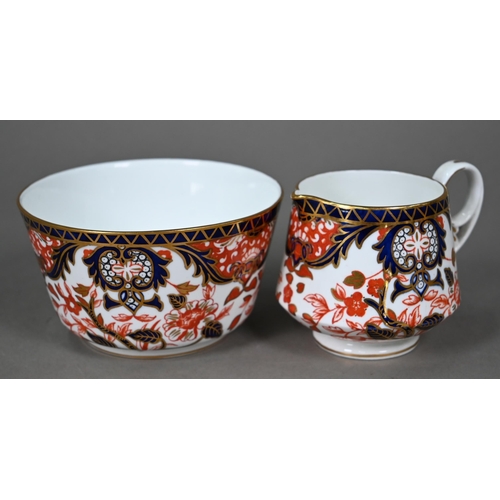 632 - A Royal Crown Derby Imari tea service comprising tea cups and saucers, twelve plates and a milk and ... 