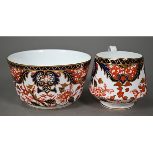 632 - A Royal Crown Derby Imari tea service comprising tea cups and saucers, twelve plates and a milk and ... 