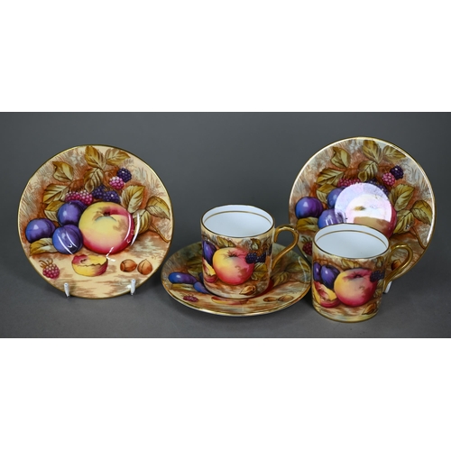 638 - A boxed set of six each Aynsley coffee cans and saucers, printed with fruit (one saucer chipped unde... 