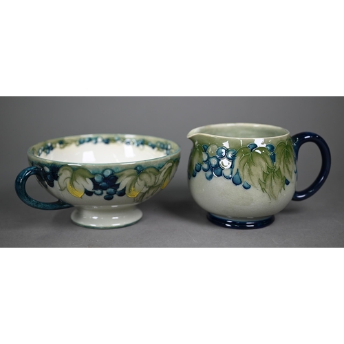 647 - A Walter Moorcroft cream and sugar pair, decorated with grapes and vines on a celadon ground, to/w t... 