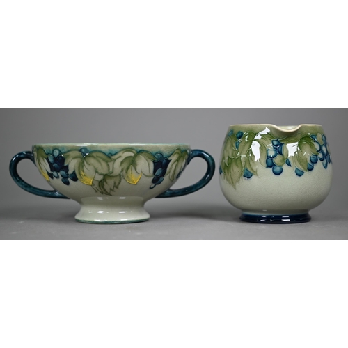 647 - A Walter Moorcroft cream and sugar pair, decorated with grapes and vines on a celadon ground, to/w t... 