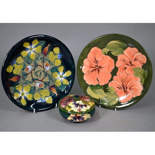 648 - A Moorcroft green-glazed 'Hibiscus' plate 26cm, with paper Royal Warrant label to/w a blue-ground 'H... 