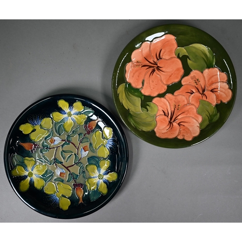 648 - A Moorcroft green-glazed 'Hibiscus' plate 26cm, with paper Royal Warrant label to/w a blue-ground 'H... 