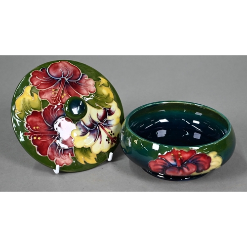 648 - A Moorcroft green-glazed 'Hibiscus' plate 26cm, with paper Royal Warrant label to/w a blue-ground 'H... 