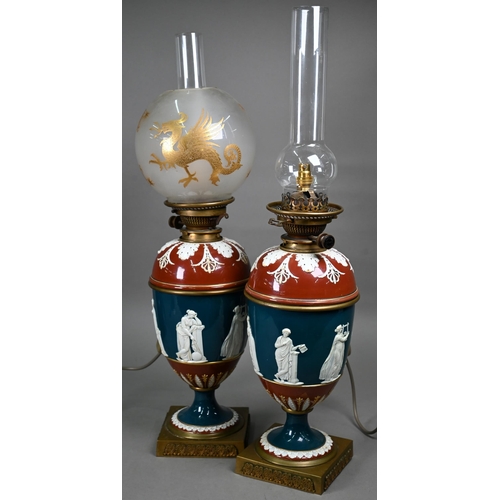 650 - A pair of Victorian glazed stoneware baluster oil-lamps with classical figures to the blue-glazed fr... 