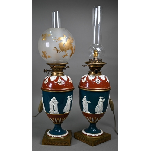 650 - A pair of Victorian glazed stoneware baluster oil-lamps with classical figures to the blue-glazed fr... 