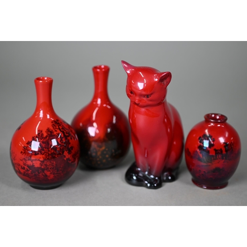 653 - A Royal Doulton Flambé seated cat, 13 cm high to/w two small onion-shaped vases, Woodcut 1606 and Ve... 