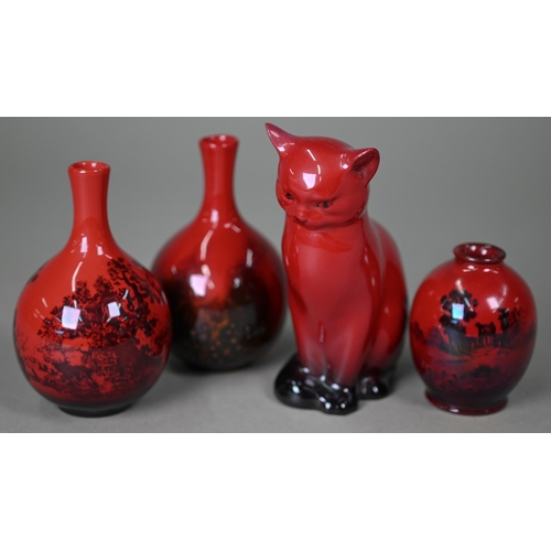 653 - A Royal Doulton Flambé seated cat, 13 cm high to/w two small onion-shaped vases, Woodcut 1606 and Ve... 