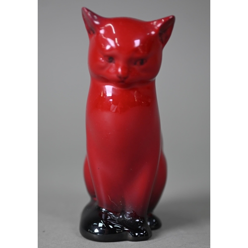 653 - A Royal Doulton Flambé seated cat, 13 cm high to/w two small onion-shaped vases, Woodcut 1606 and Ve... 