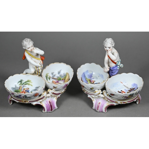 674 - Two 19th century Berlin porcelain double salts, modelled as putti, their baskets painted with courti... 