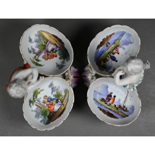 674 - Two 19th century Berlin porcelain double salts, modelled as putti, their baskets painted with courti... 