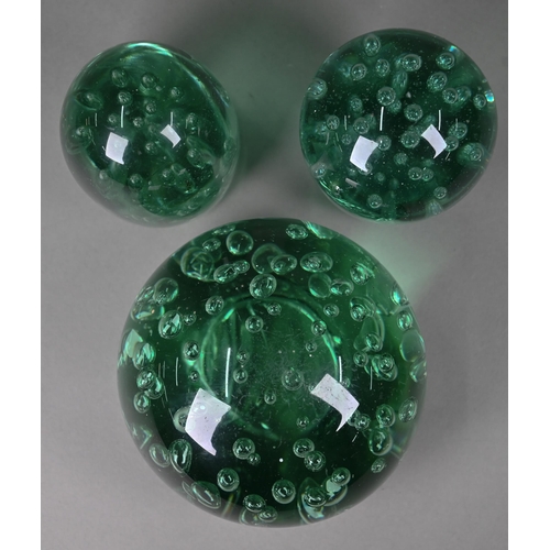 686 - Four Stourbridge green glass 'dumps' with internal floral designs to/w three dumps with bubbles, 12.... 