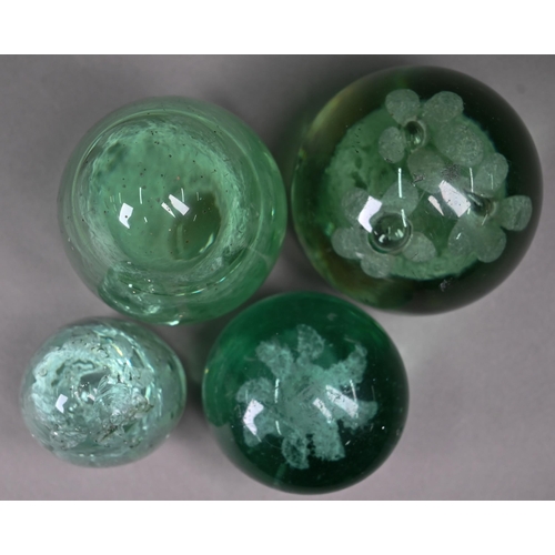 686 - Four Stourbridge green glass 'dumps' with internal floral designs to/w three dumps with bubbles, 12.... 