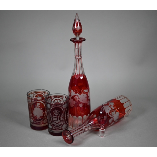 687 - A pair of 19th century German ruby flash glass beakers, cut and etched with armorials, floral sprays... 