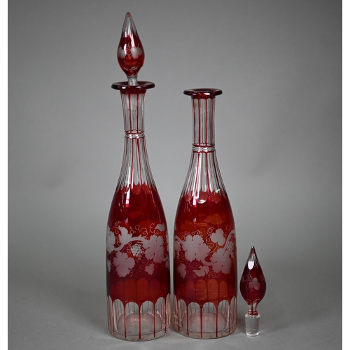 687 - A pair of 19th century German ruby flash glass beakers, cut and etched with armorials, floral sprays... 