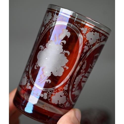 687 - A pair of 19th century German ruby flash glass beakers, cut and etched with armorials, floral sprays... 