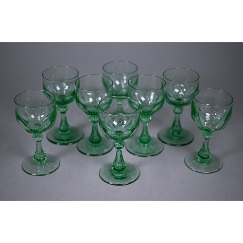 688 - A set of eight green cut wine-glasses with hollow baluster stems and ground-out pontils