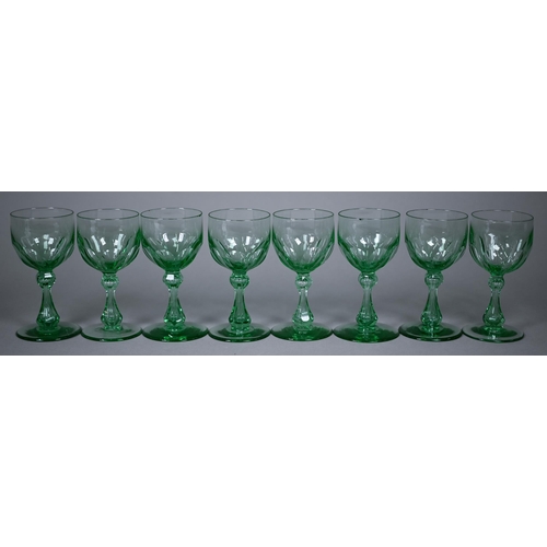 688 - A set of eight green cut wine-glasses with hollow baluster stems and ground-out pontils