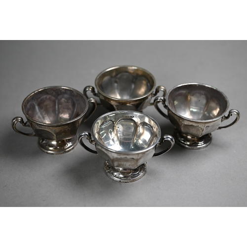 77 - A set of four silver salts with scroll handles and stemmed foot, Sibray, Hall & Co., Sheffield 1... 