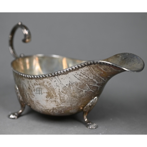 81 - An Edwardian silver sauce boat on shell feet, Birmingham 1905, to/w drum mustard with clear glass li... 