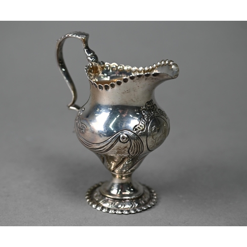 91 - A Victorian silver Rococo Revival pear-shaped cream jug with embossed scrolling decoration, Daniel &... 