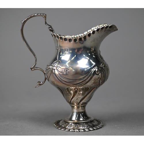 91 - A Victorian silver Rococo Revival pear-shaped cream jug with embossed scrolling decoration, Daniel &... 