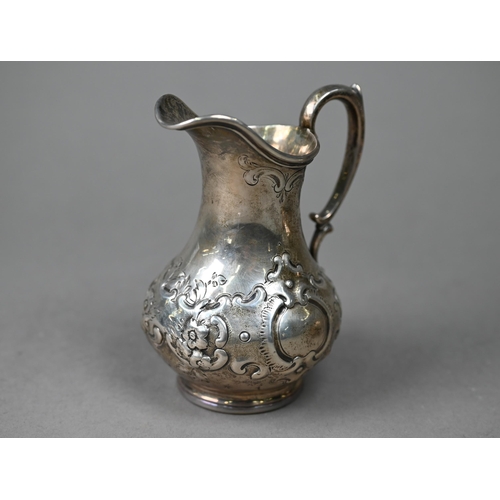 91 - A Victorian silver Rococo Revival pear-shaped cream jug with embossed scrolling decoration, Daniel &... 