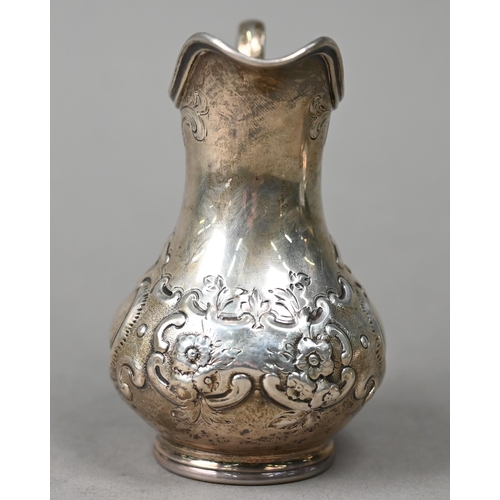 91 - A Victorian silver Rococo Revival pear-shaped cream jug with embossed scrolling decoration, Daniel &... 