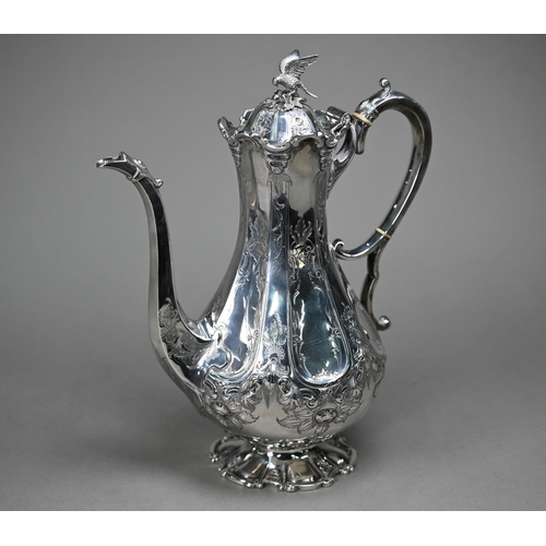 94 - A Victorian silver coffee pot with falcon finial and engraved decoration, the scroll handle with ivo... 