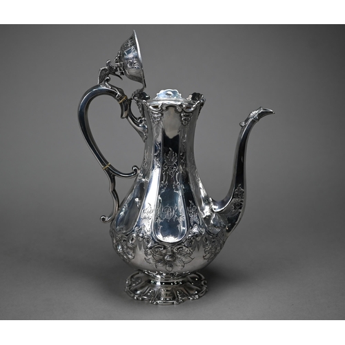 94 - A Victorian silver coffee pot with falcon finial and engraved decoration, the scroll handle with ivo... 