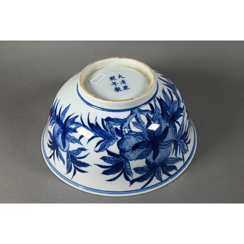 584 - A Chinese blue and white bowl painted with fruiting pomegranate sprays, the base with six-character ... 