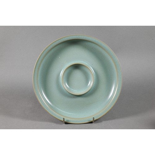 586 - A Chinese Longquan celadon style circular teapot stand covered overall with an even blue/green glaze... 