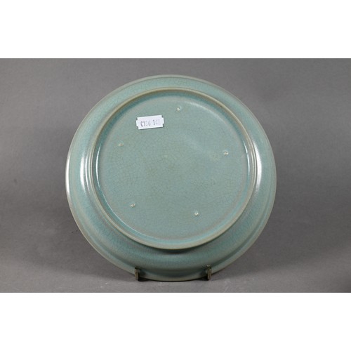 586 - A Chinese Longquan celadon style circular teapot stand covered overall with an even blue/green glaze... 