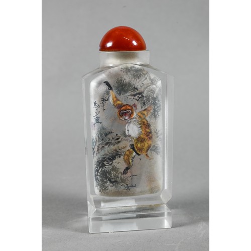 585 - A 20th century Chinese inside painted glass snuff bottle with orange glass stopper painted with Maca... 