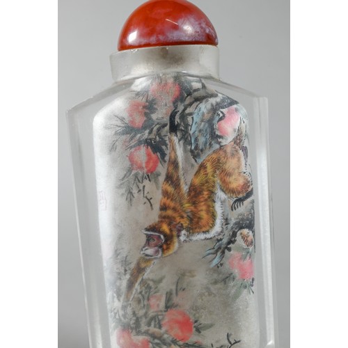 585 - A 20th century Chinese inside painted glass snuff bottle with orange glass stopper painted with Maca... 