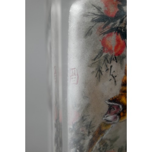 585 - A 20th century Chinese inside painted glass snuff bottle with orange glass stopper painted with Maca... 