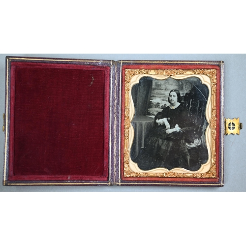 1021 - Four Ambrotype photographic portraits of ladies and a gentleman, in gilt mounts and leather pocket-c... 