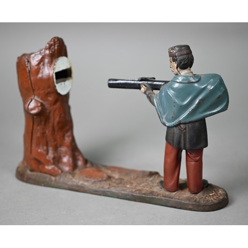 1060 - An antique novelty cold-painted iron money-box, cast as a soldier aiming at a tree