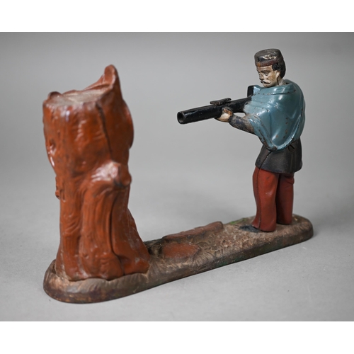 1060 - An antique novelty cold-painted iron money-box, cast as a soldier aiming at a tree