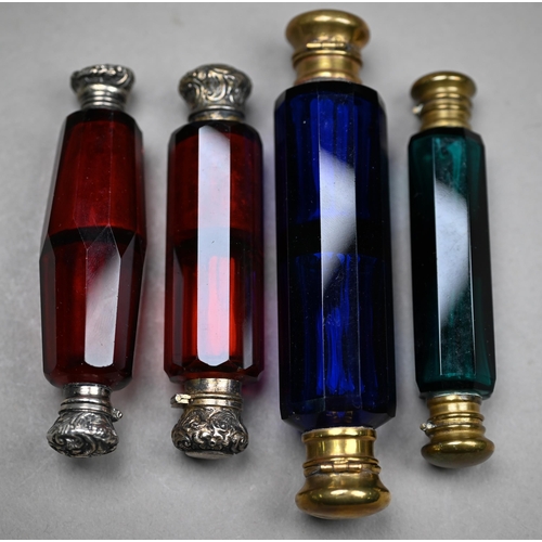 1082 - Two Victorian ruby glass double-ended scent bottles with unmarked white metal caps, a blue example a... 