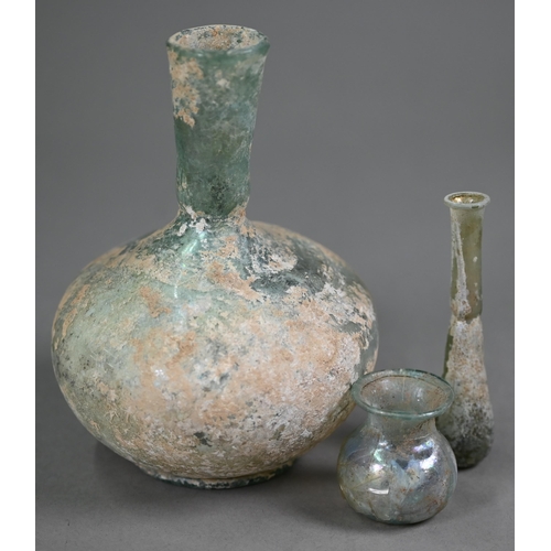 1093 - A Roman glass onion-shaped bottle-vase, 15 cm high to/w a small vial and a small globular pot with f... 