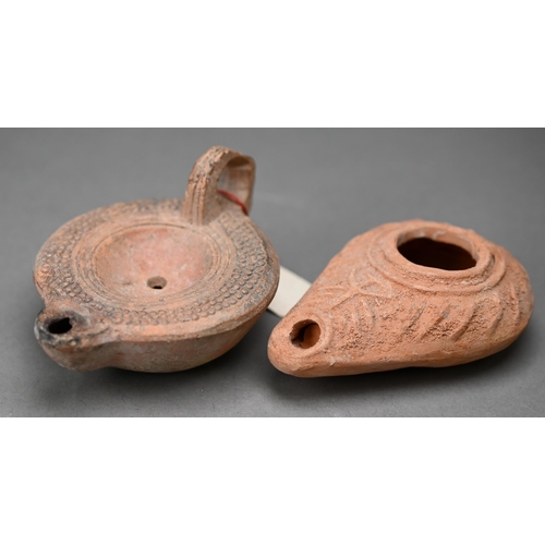 1094 - Three antiquity terracotta oil lamps to/w a later example and a reproduction metal lamp (5)