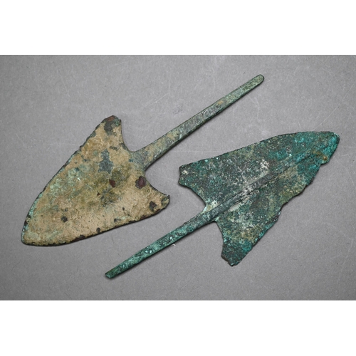 1100 - A Bronze Age dagger blade with shallow diamond section, 25 cm and a plainer 29 cm example, to/w a sp... 