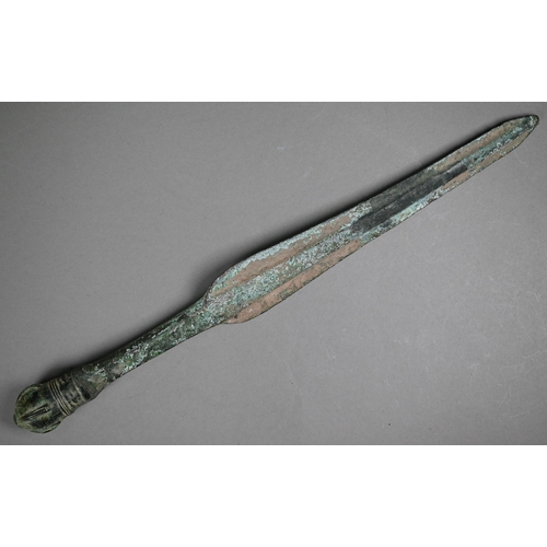 1102 - A Bronze Age shortsword, the shaped blade with thick raised midrib, with crown pommel, 41.5 cm long ... 